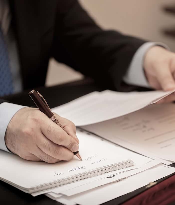 man writing on paper