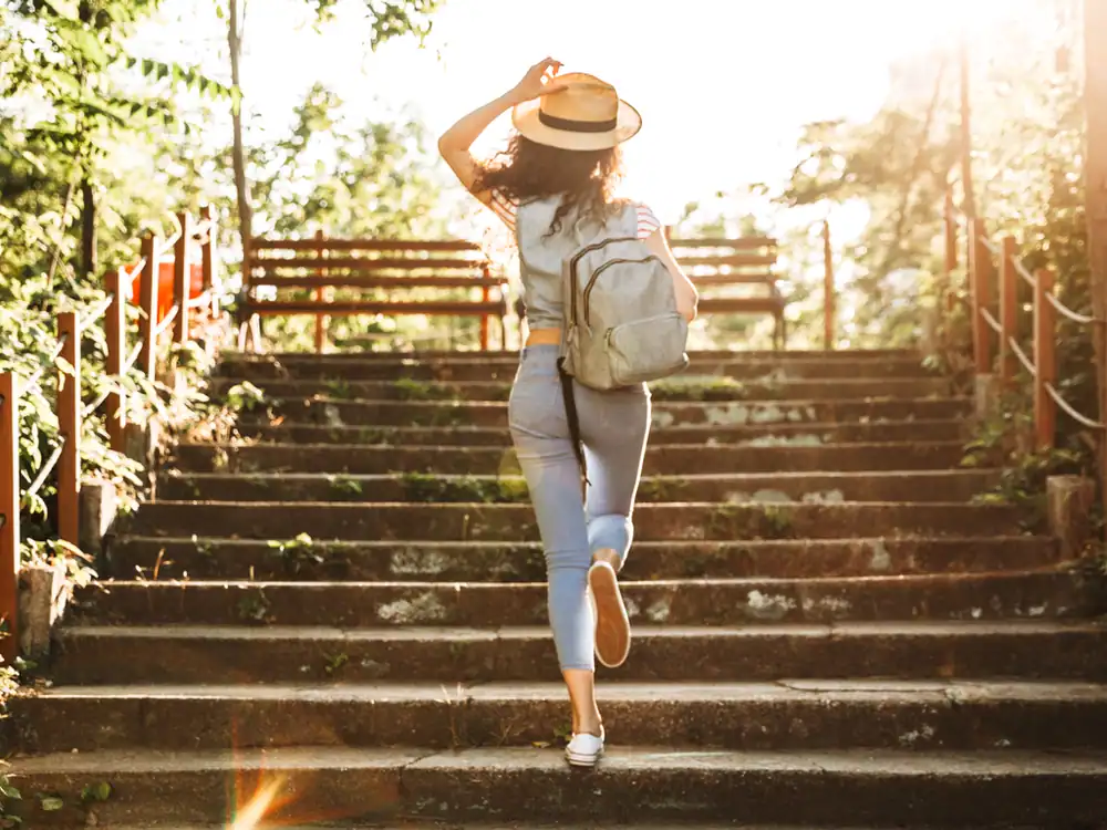 person walking up on stairs in a sunset