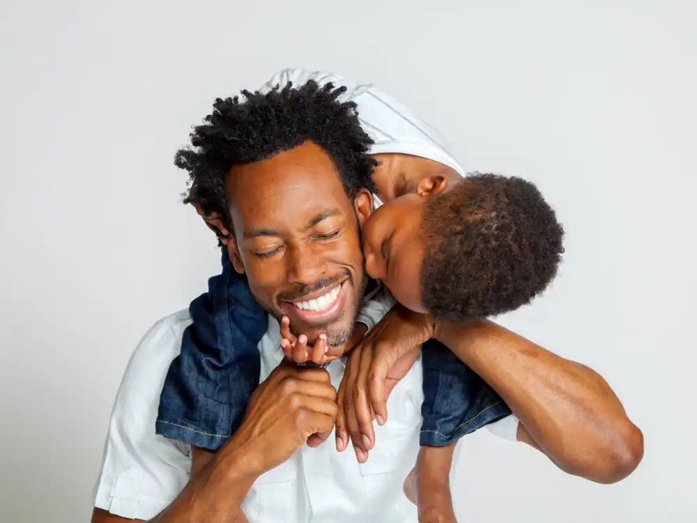 son kissing a dad